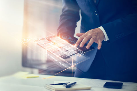 Man in dark suit using a tablet computer